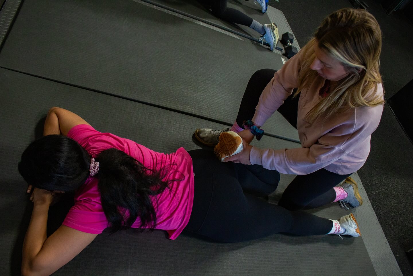 Joss coaching a client through floor work