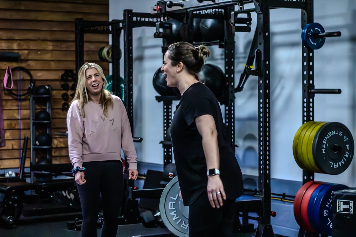 Joss with a client in front of the rack wall at Top Yard Barn